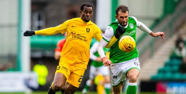 Christian Doidge and Efe Ambrose battle for the ball during the last meeting  between Hibs and Livingston