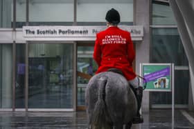 A mounted fox hunter rides through the Capital to highlight the fact that the cruel pastime of fox hunting is still happening