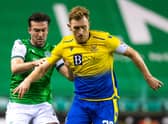 Stevie Mallan battles for the ball with former Hibs midfielder Liam Craig