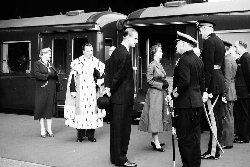 Queen Elizabeth II and the Duke of Edinburgh chat with Lt-General Sir Colin Barber before boarding the Royal Train at Princes Street station, Edinburgh.  The Duke is with Rear-Admiral JHF Crombie, while Lord Provost Sir James Miller and his wife stand behind.