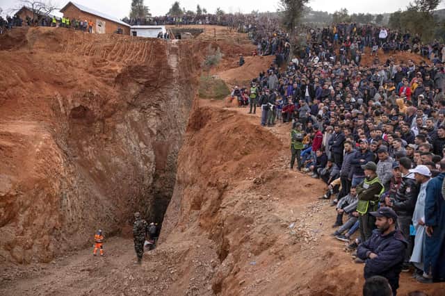 Bystanders watch as emergency teams work to rescue five-year-old Rayan Oram from a well shaft in the remote village of Ighrane in Morocco (Picture: Fadel Senna/AFP via Getty Images)