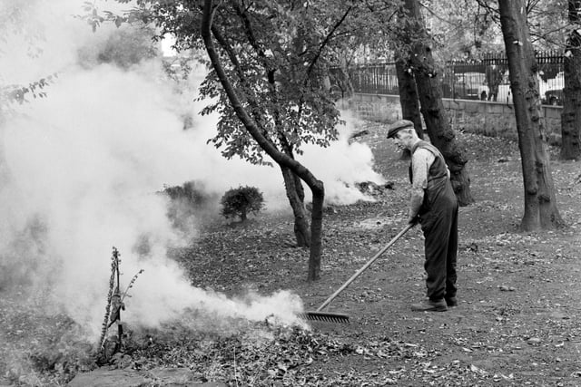 A gardener is pictured burning fallen leaves in the private gardens at Queen Street, Edinburgh, in October 1972.