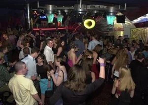 Saturday night revellers throwing shapes on the dancefloor at Eros Elite, Fountainbridge, 2 September 2000.