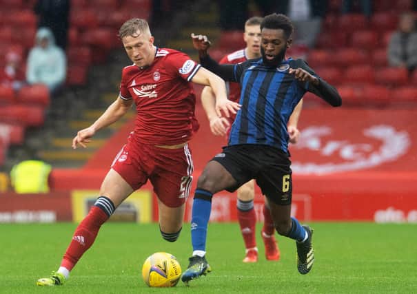 Aberdeen's Ross McCrorie competes with Hearts' Beni Baningime at Pittodrie.