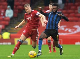 Aberdeen's Ross McCrorie competes with Hearts' Beni Baningime at Pittodrie.
