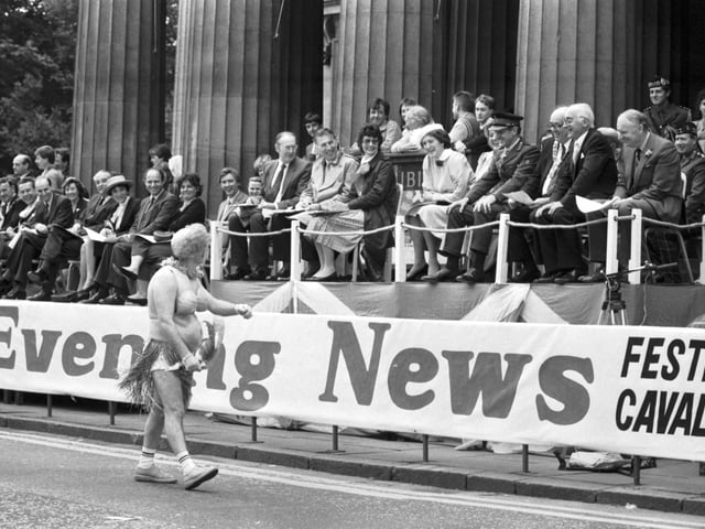 A man dressed as a 'South Sea Islander' causes great hilarity as he passes the VIP stand during the Edinburgh Festival Cavalcade in August 1985