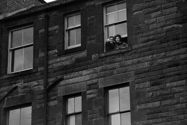 Danny Paton and his wife Sandra look down on Tynecastle football ground from the window of their Gorgie Road home in December 1962.