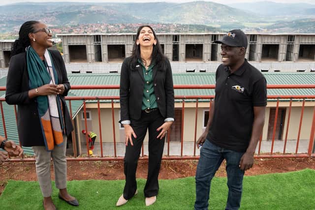 Home Secretary Suella Braverman laughs as she tours a building site on the outskirts of Kigali, Rwanda, where deported migrants are planned to be housed (Picture: Stefan Rousseau/PA)
