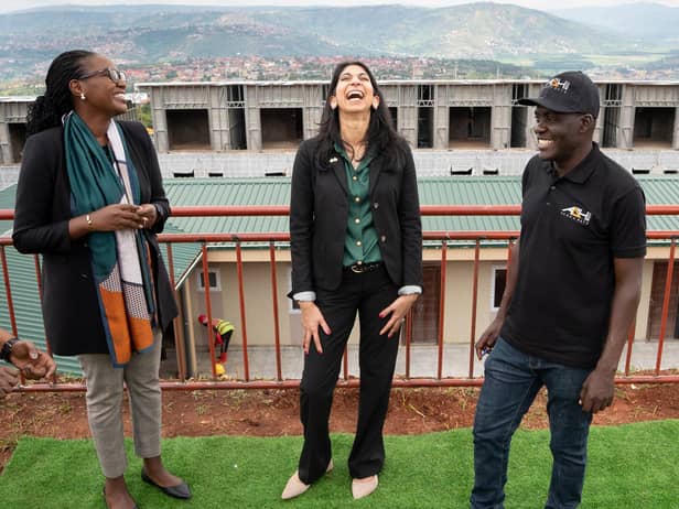 Home Secretary Suella Braverman laughs as she tours a building site on the outskirts of Kigali, Rwanda, where deported migrants are planned to be housed (Picture: Stefan Rousseau/PA)