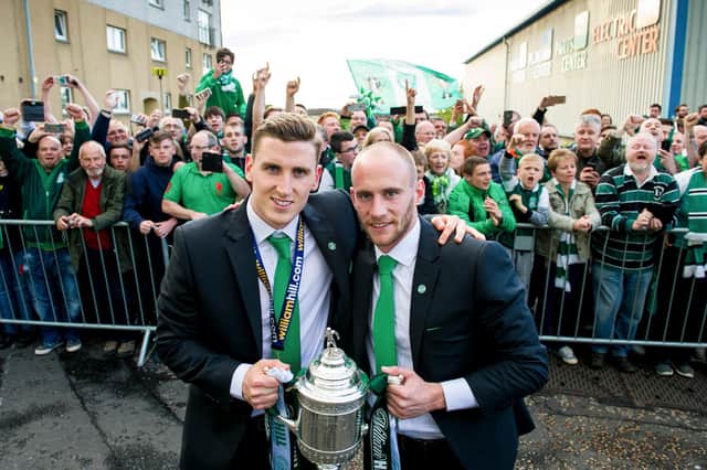 Hibs' Paul Hanlon (left) and David Gray celebrate with the fans after winning the 2016 Scottish Cup final. Photo Ross Parker/SNS Group