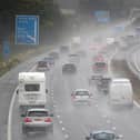 Persistent downpours are expected to bring flooding and transport disruption, with more than 20 flood alerts in place.