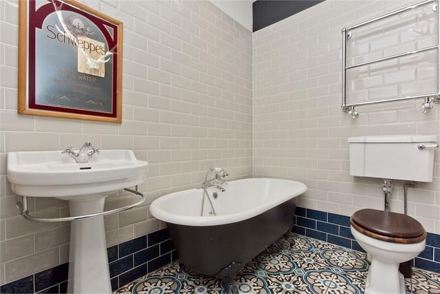 The stylish family bathroom, with metro tiling and a freestanding roll-top bathtub.