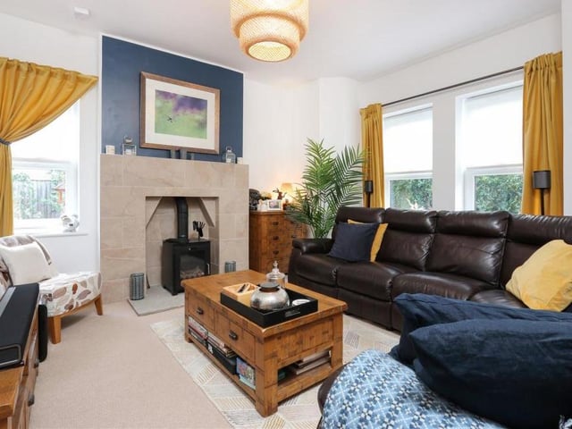 Here you can see how the feature fireplace fits into the living room. It's a luscious, bay-fronted room that oozes comfort and warmth.