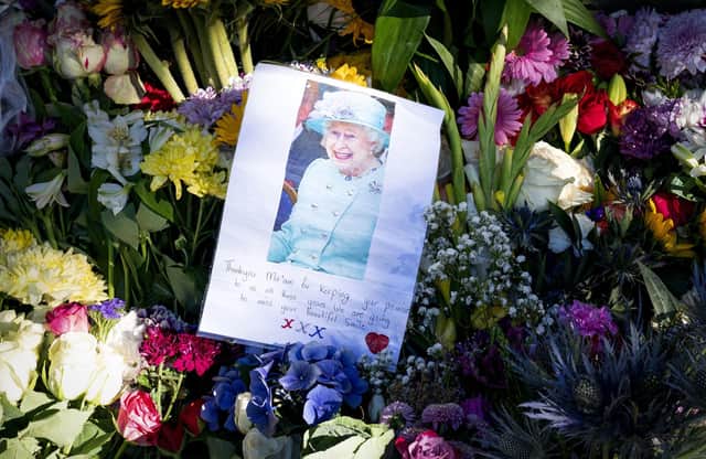 Floral tributes and messages left by the public at the Palace of Holyroodhouse, Edinburgh, following the death of Queen Elizabeth II on Thursday.  
Photo: Jane Barlow/PA Wire