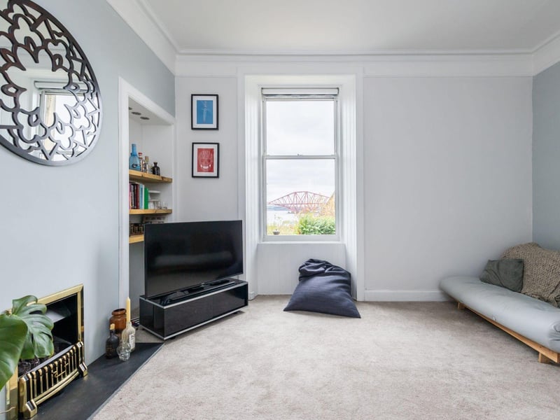 The main reception room also offers picturesque views of the Forth Rail Bridge and includes a cozy fireplace and could be use flexibly as a third bedroom.