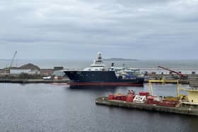 The US Navy owned Petrel is back in the water more than a month after it toppled over in Leith Docks in Edinburgh.