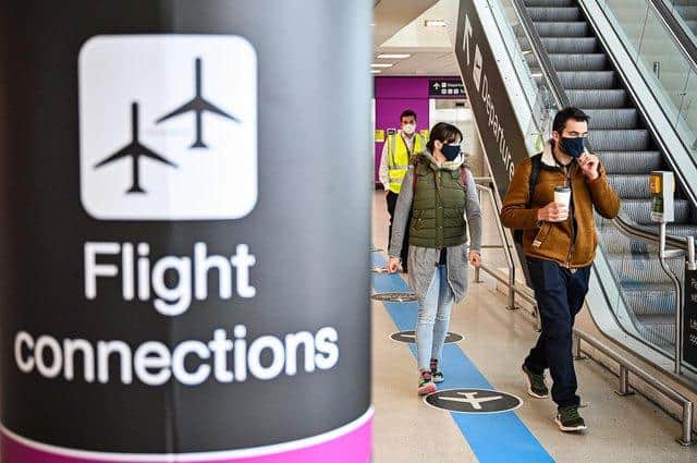 Travellers wearing face masks at Edinburgh Airport.