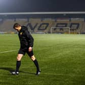 Referee Steven McLean inspects the pitch at Livingston.