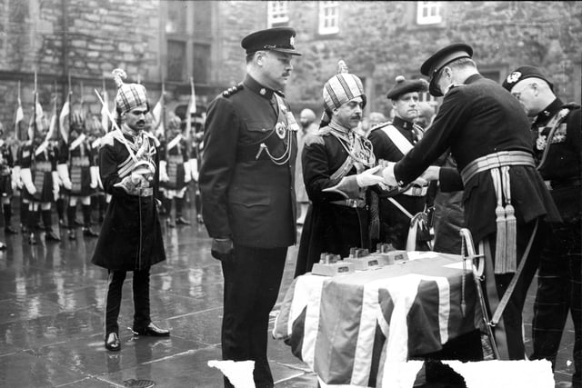 Lieutenant General Sir William F R Turner presenting visiting troops with silver statuettes of Edinburgh Castle for their contribution to the Military Tattoo in 1962.