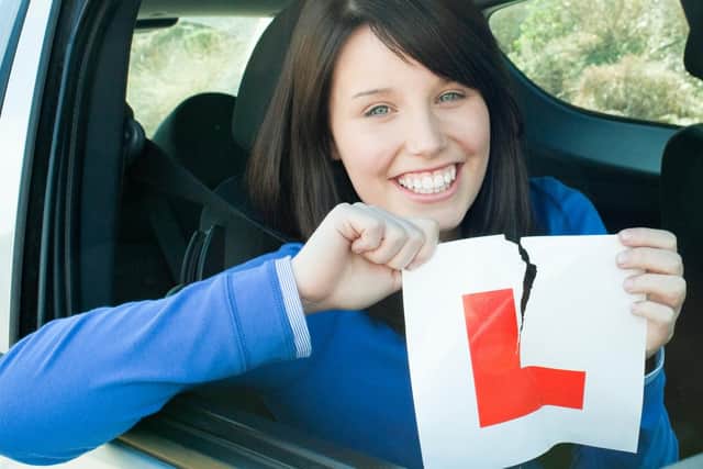 A teen smiles after passing  her driving test