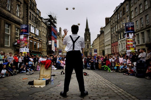This street performer attracted a large crowd on the High Street, Edinburgh, during the Fringe in 2004.