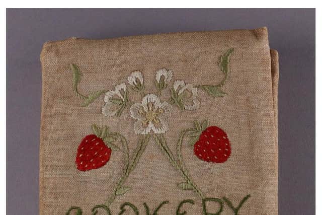 The edition of Plain Cookery Recipes from which the recipe in Cooking Up the Past was taken is enclosed in a beautiful linen cover, embroidered with strawberries, by a student at the College.