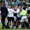 Players and staff from both teams clash at full time after the 1-1 derby draw at Tynecastle