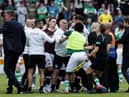 Players and staff from both teams clash at full time after the 1-1 derby draw at Tynecastle