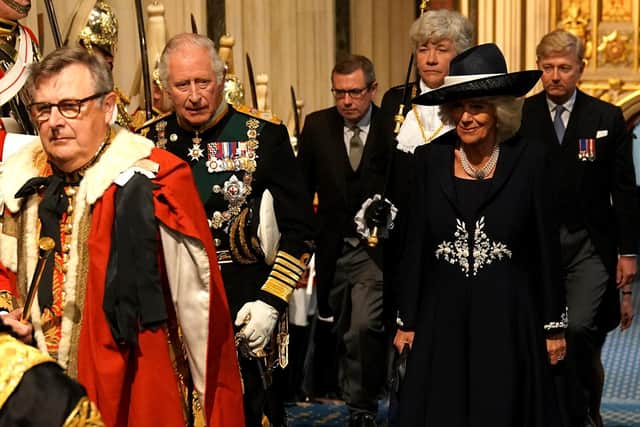 The Prince of Wales and the Duchess of Cornwall walk past the Household Cavalry in the Norman Porch at the Palace of Westminster ahead of the State Opening of Parliament in the House of Lords, London. Picture date: Tuesday May 10, 2022.
