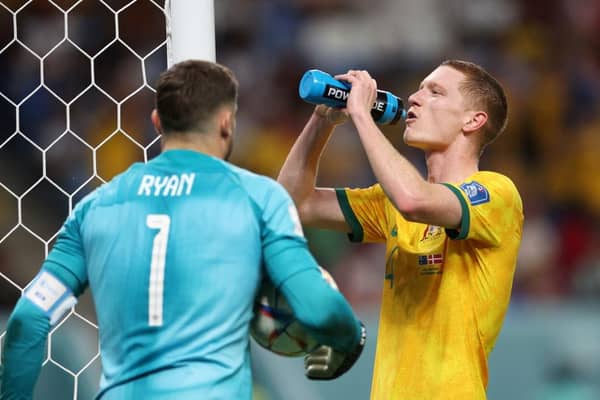 Kye Rowles takes a well-earned water break as Australia defeat Denmark to reach the last 16 of the World Cup. Picture: Getty