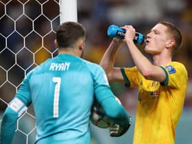 Kye Rowles takes a well-earned water break as Australia defeat Denmark to reach the last 16 of the World Cup. Picture: Getty