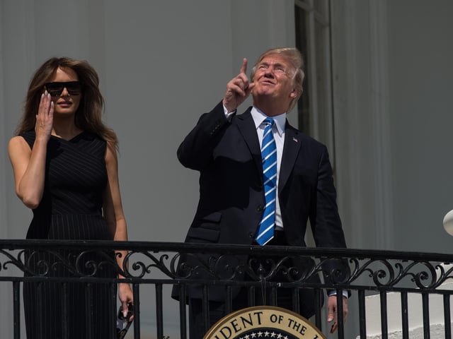 US President Donald Trump with First Lady Melania Trump on the balcony of the White House to look at the solar eclipse.  "Everything will be fine Mr. President, so long as you don't look directly at the su....."