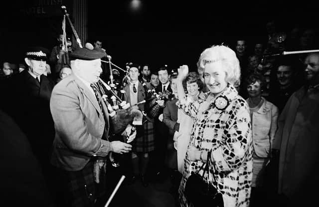 Winnie Ewing (right), the newly-elected Scottish National Party (SNP) Member of Parliament for Hamilton is welcomed by supporters, including two highland bagpipers, as she arrives in London to take up her seat in the House of Commons in November 1967 (Picture: Terry Fincher/Daily Express/Hulton Archive/Getty Images)
