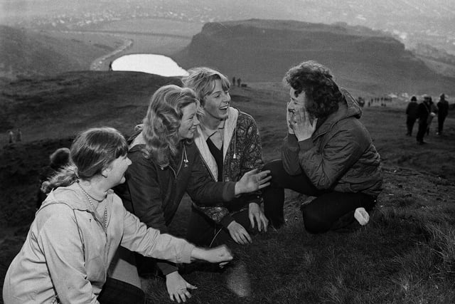 Four girls wash their faces in the morning dew as the sun comes up on May Day morning on Arthur's Seat in 1965.