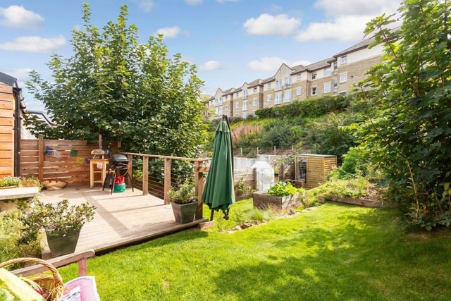 To the rear of the property, there is an enclosed garden that boasts a suntrap, south-facing aspect. It is well maintained and features a neat lawn, framed by mature planting, and a decked area for alfresco dining in the summer. On-street parking is also available in the vicinity.