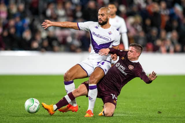 Cammy Devlin challenges Sofyan Amrabat during the Europa Conference League defeat at Tynecastle. The Hearts midfielder was introduced as a second-half sub. Picture: SNS