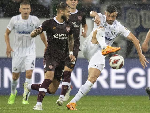 Hearts' Jorge Grant is kept at bay by Zurich's Blerim Dzemaili