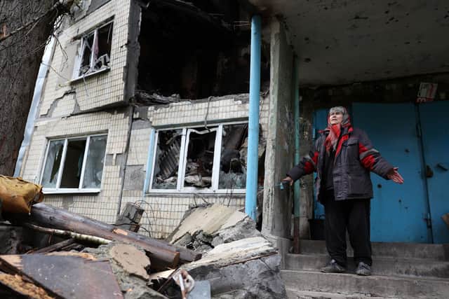 Local resident Ludmyla, 76, stands in front of a heavily damaged residential building in the frontline town of Avdiivka, Donetsk region (Picture: Anatolii Stepanov/AFP via Getty Images)