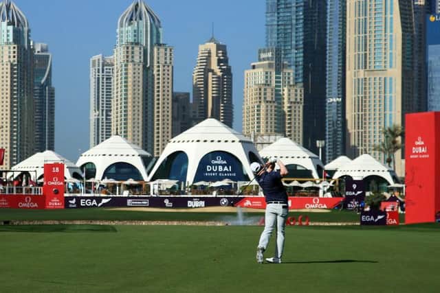 Clubhouse leader Bob MacIntyre plays his second shot on the 18th hole on the Majlis Course in the second round. Picture: Andrew Redington/Getty Images.