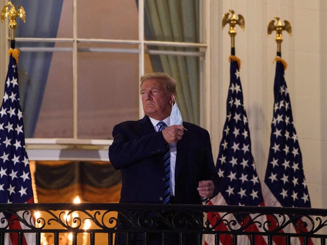 President Donald Trump takes off his facemask as he arrives at the White House upon his return from Walter Reed Medical Center, where he underwent treatment for Covid-19. 
 The White House released a video of Trump returning to the White House in triumphant form.  He later went on to declare that he was now 'indestructable'