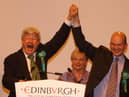 Robin Harper, Scotland's first Green parliamentarian, celebrates with Mark Ballard, who had just been elected as the party's second MSP for Lothian alongside Mr Harper.
The Greens made other gains across Scotland, increasing their total representation in the Scottish Parliament from two to seven.  
Mr Harper served as co-convener of the party until 2008 and remained an MSP until steping down at the 2011 election. Mr Ballard served only one term before leaving the parliament in 2007.
 


Scottish Parliament elections 2003 - Meadowbank Count.The Greens' Robin Harper (l) and Mark Ballard salute their victories as list MSPs for the Lothians.Pic.... Neil Hanna

Scottish Parliament elections 2003 - Meadowbank Count.
The Greens' Robin Harper (l) and Mark Ballard salute their victories as list MSPs for the Lothians.
Pic.... Neil Hanna