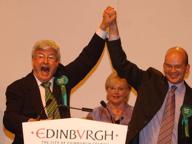 Robin Harper, Scotland's first Green parliamentarian, celebrates with Mark Ballard, who had just been elected as the party's second MSP for Lothian alongside Mr Harper.
The Greens made other gains across Scotland, increasing their total representation in the Scottish Parliament from two to seven.  
Mr Harper served as co-convener of the party until 2008 and remained an MSP until steping down at the 2011 election. Mr Ballard served only one term before leaving the parliament in 2007.
 


Scottish Parliament elections 2003 - Meadowbank Count.The Greens' Robin Harper (l) and Mark Ballard salute their victories as list MSPs for the Lothians.Pic.... Neil Hanna

Scottish Parliament elections 2003 - Meadowbank Count.
The Greens' Robin Harper (l) and Mark Ballard salute their victories as list MSPs for the Lothians.
Pic.... Neil Hanna