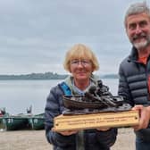 Jean Ferguson receives the Scottish Ladies fly fishing trophy from Quint Glen, manager of Lake of Menteith Fishery.