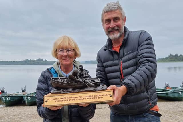 Jean Ferguson receives the Scottish Ladies fly fishing trophy from Quint Glen, manager of Lake of Menteith Fishery.