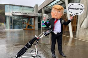 Protester standing outside Scottish Parliament building in Edinburgh ahead of MSPs debate on Donald Trump's financing of some of Scotland's golf courses picture: Lisa Ferguson/JPI Media