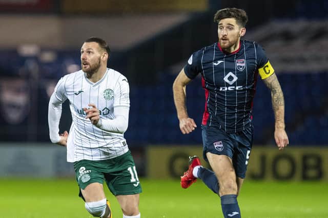 Martin Boyle and Ross County's Jack Baldwin in action during Hibs' defeat in the Highlands last season. Picture: SNS
