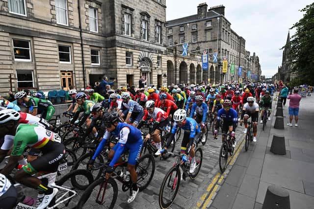 Riders cycle down the Royal Mile at the start of the men's Elite Road Race at the Cycling World Championships in Edinburgh on August 6