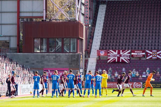 The Inverness players applaud Hearts on to the field at Tynecastle.