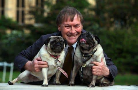 Conservative MP David Amess with his pugs, Lily and Boat at the Westminster Dog of the Year competition at Victoria Tower Gardens in London