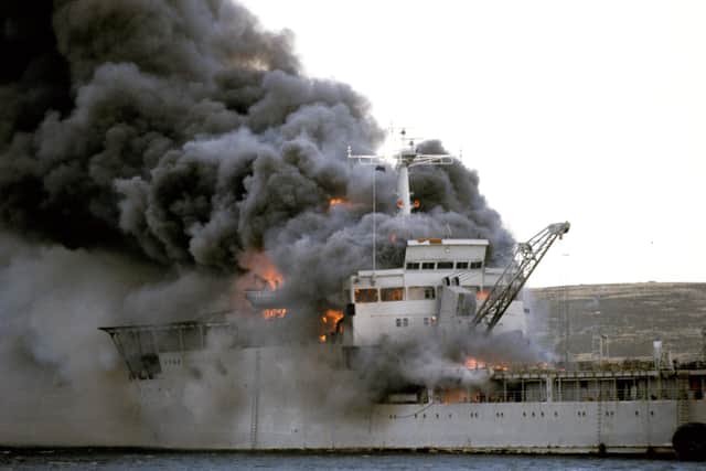 The Landing Ship Logistic RFA Sir Galahad ablaze after the Argentine air raid on June 8th at Bluff Cove near Fitzroy settlement on East Falkland. Photo: Martin Cleaver/PA Wire.